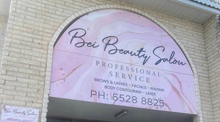 Entrance sign of Bei Beauty Salon in Biggera Waters, Queensland, AU showcasing services like facials and waxing.