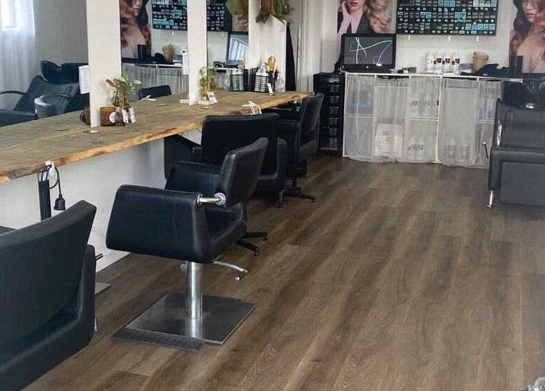 Chic interior of Uneek Hair, Tanilba Bay, New South Wales, AU with modern styling stations and elegant decor.