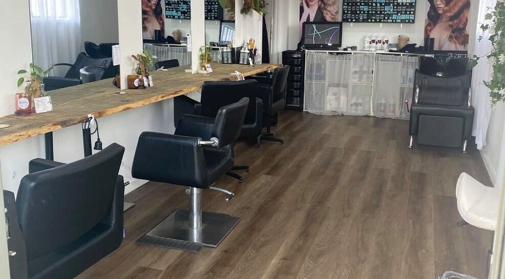 Chic interior of Uneek Hair, Tanilba Bay, New South Wales, AU with modern styling stations and elegant decor.