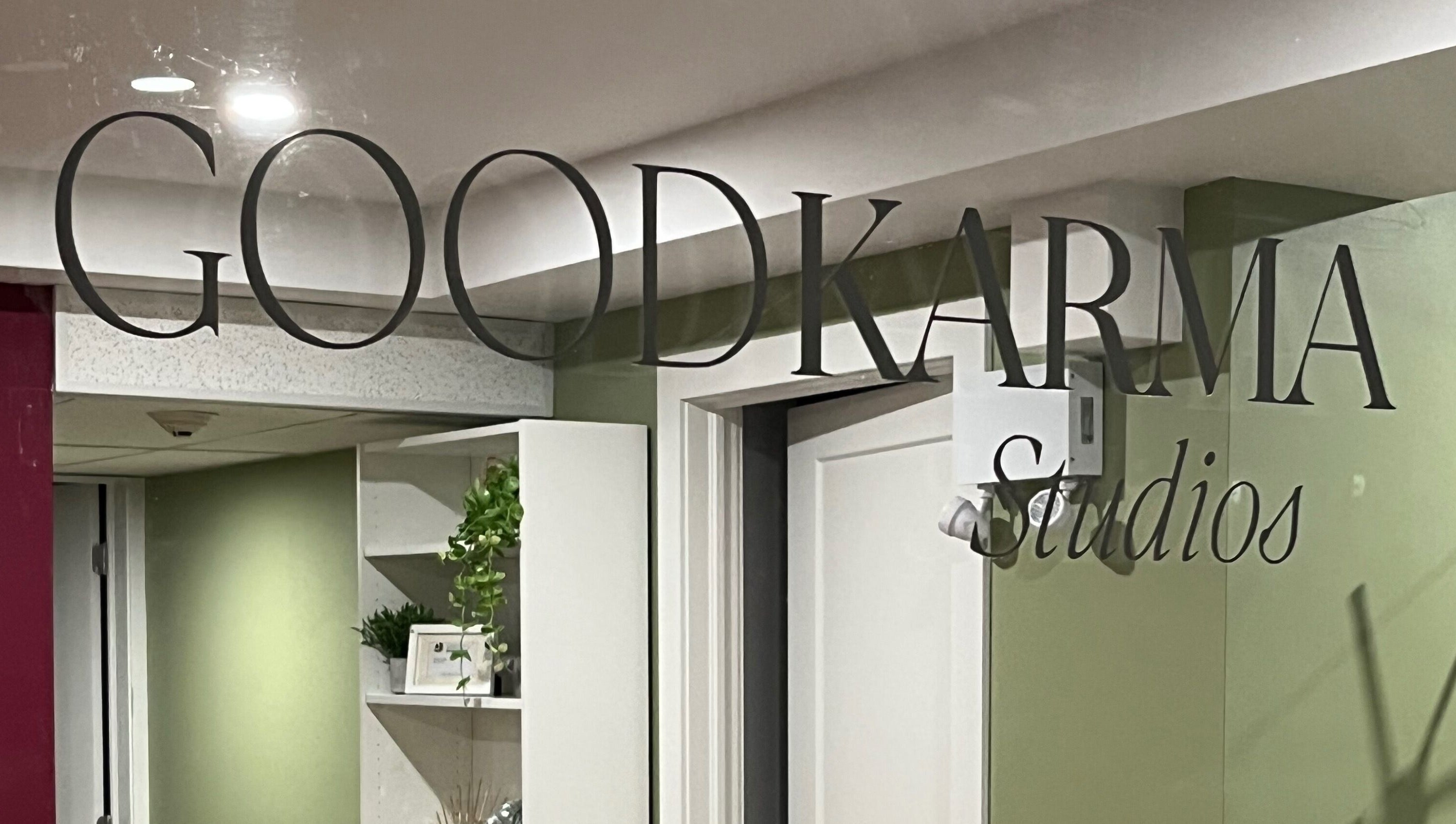 Entrance sign of Good Karma Studios in Lower Sackville, Nova Scotia, CA, welcoming visitors warmly.