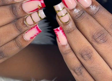 Intricate nail art at Vxsnail Studio in Spanish Town, St. Catherine Parish, JM featuring red and gold designs.