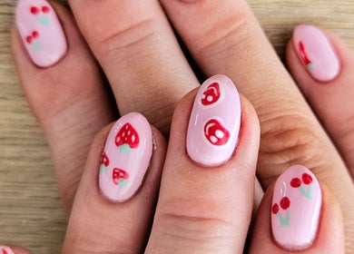 Fruit-themed nail art at Whisk Beauty, Blenheim, Marlborough, NZ. Pink polish with strawberries and cherries design.