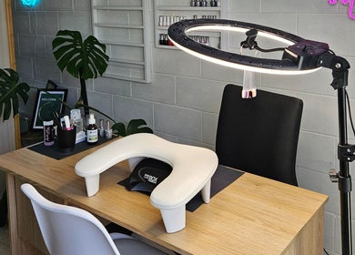 Nail station setup at Whisk Beauty, Blenheim, Marlborough, NZ with lighting, plants, and manicure tools.