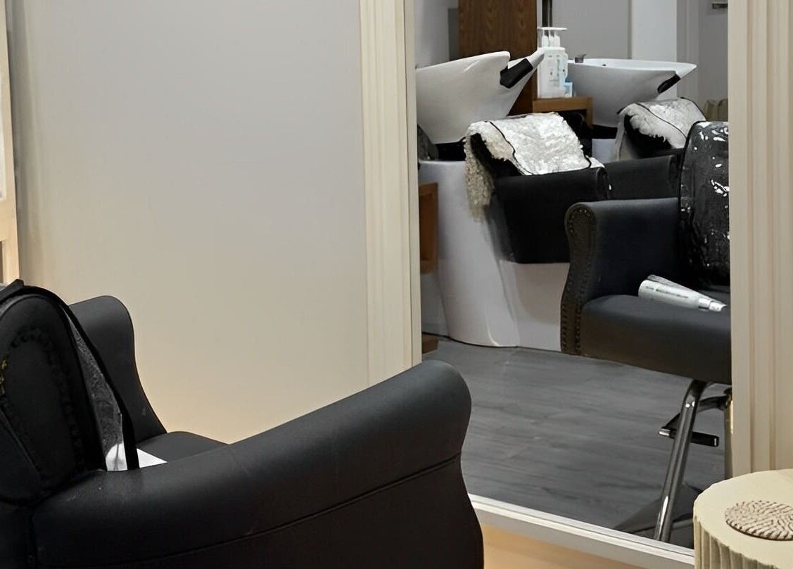 Luxurious salon interior at House Of Serenity, Ferring, England, GB featuring modern chairs and mirrors.