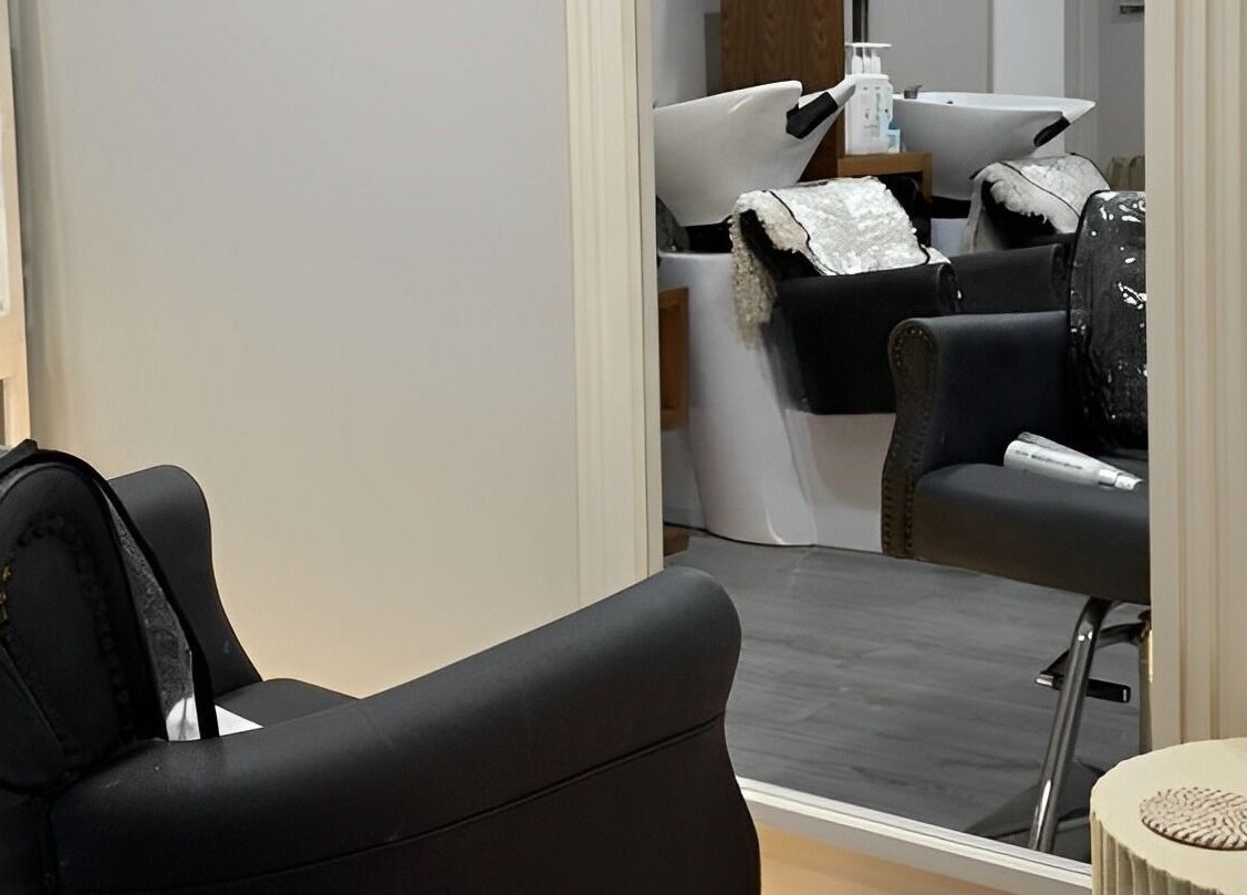 Luxurious salon interior at House Of Serenity, Ferring, England, GB featuring modern chairs and mirrors.