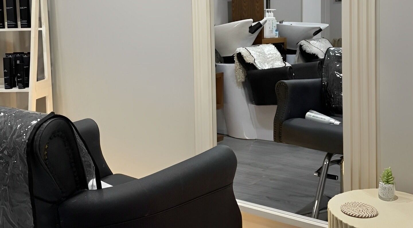 Luxurious salon interior at House Of Serenity, Ferring, England, GB featuring modern chairs and mirrors.