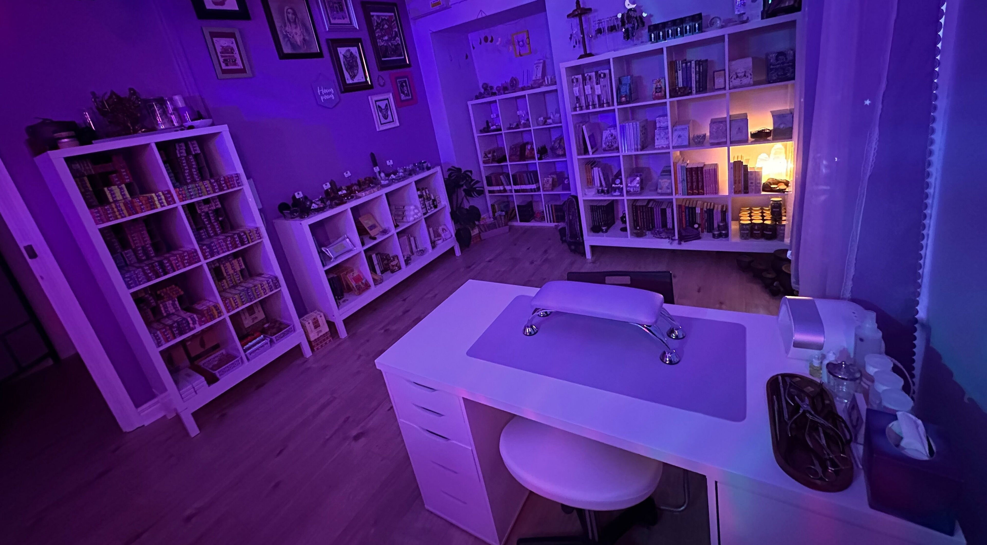 Cozy nail salon interior at Sigil + Skin in Sunderland, United Kingdom, GB with purple ambient lighting.