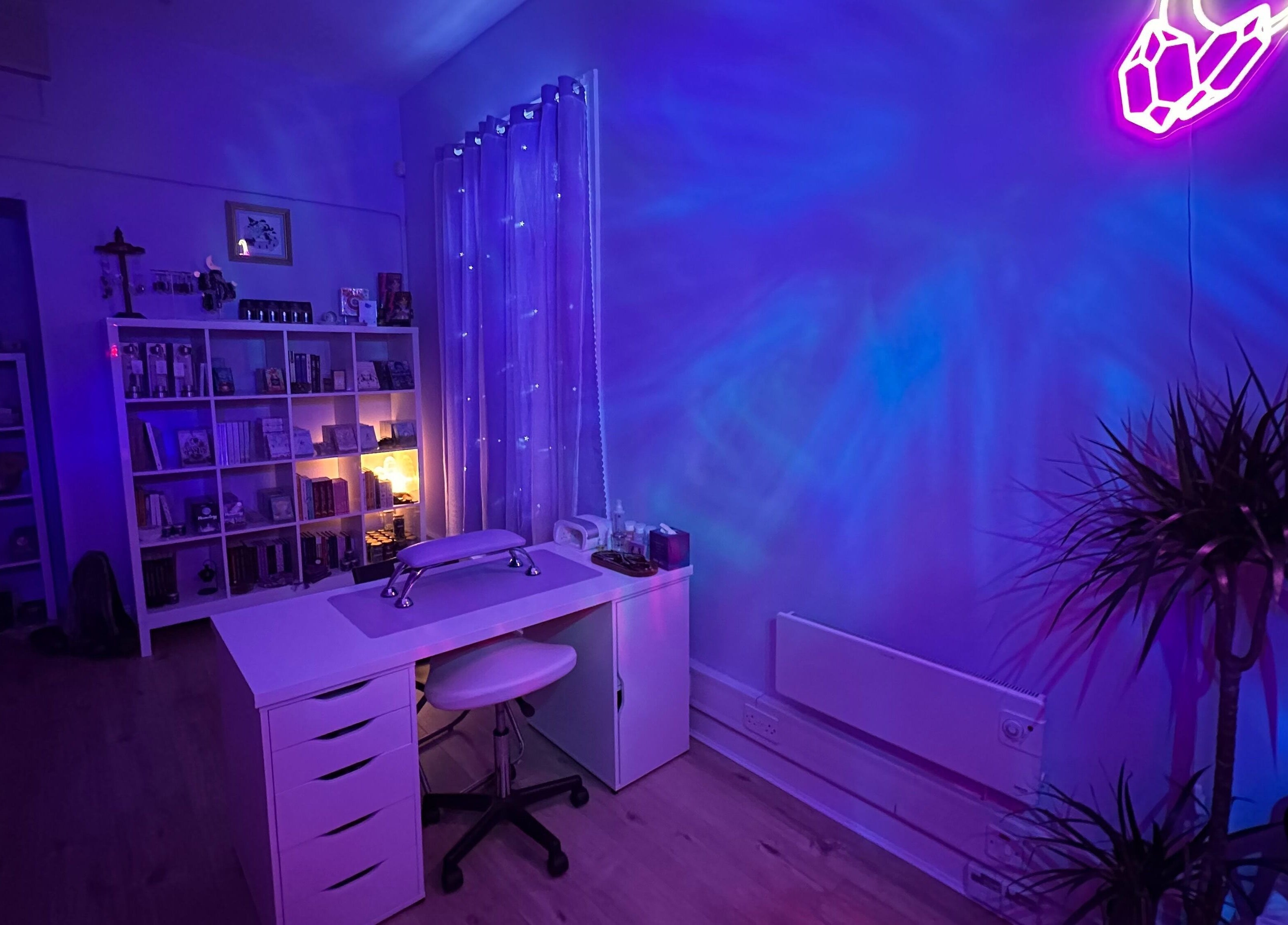 Serene treatment room at Sigil + Skin in Sunderland, United Kingdom, GB with calming blue and purple lighting.