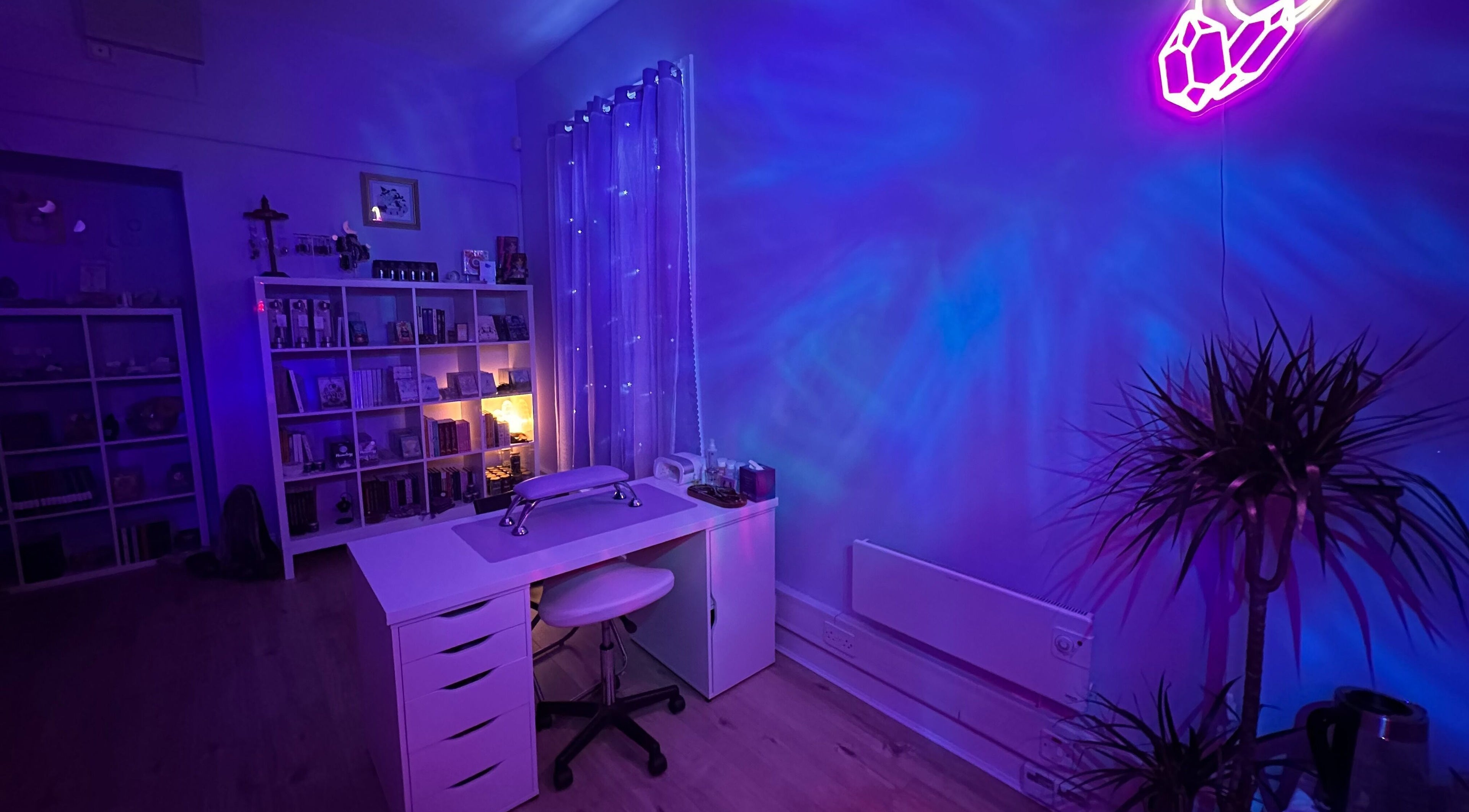 Serene treatment room at Sigil + Skin in Sunderland, United Kingdom, GB with calming blue and purple lighting.