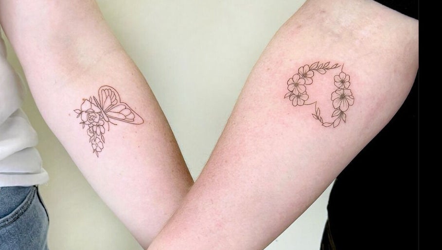 Floral tattoos on arms at Thi Aim, Richmond, South Australia, AU, showcasing delicate linework.