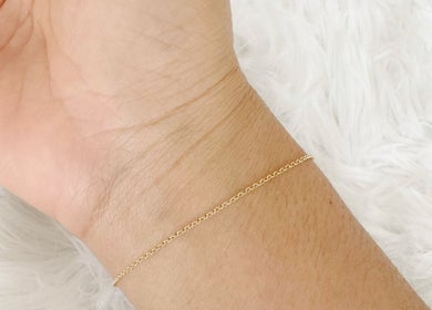 Delicate gold chain bracelet on wrist at Thi Aim, Richmond, South Australia, AU.
