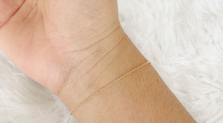 Delicate gold chain bracelet on wrist at Thi Aim, Richmond, South Australia, AU.