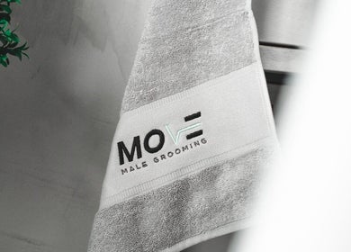 Luxurious towel with Move Salon Inchicore logo, Dublin, County Dublin, IE, showcasing premium grooming space.