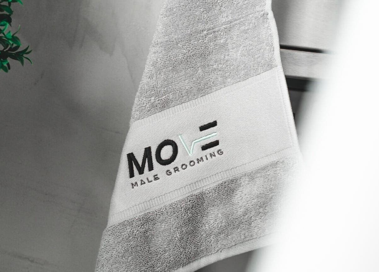 Luxurious towel with Move Salon Inchicore logo, Dublin, County Dublin, IE, showcasing premium grooming space.