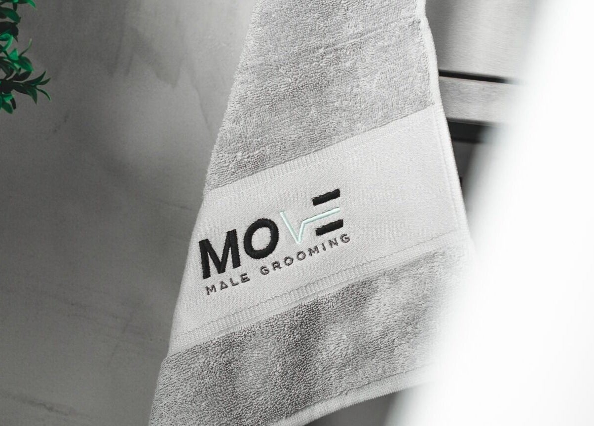 Luxurious towel with Move Salon Inchicore logo, Dublin, County Dublin, IE, showcasing premium grooming space.