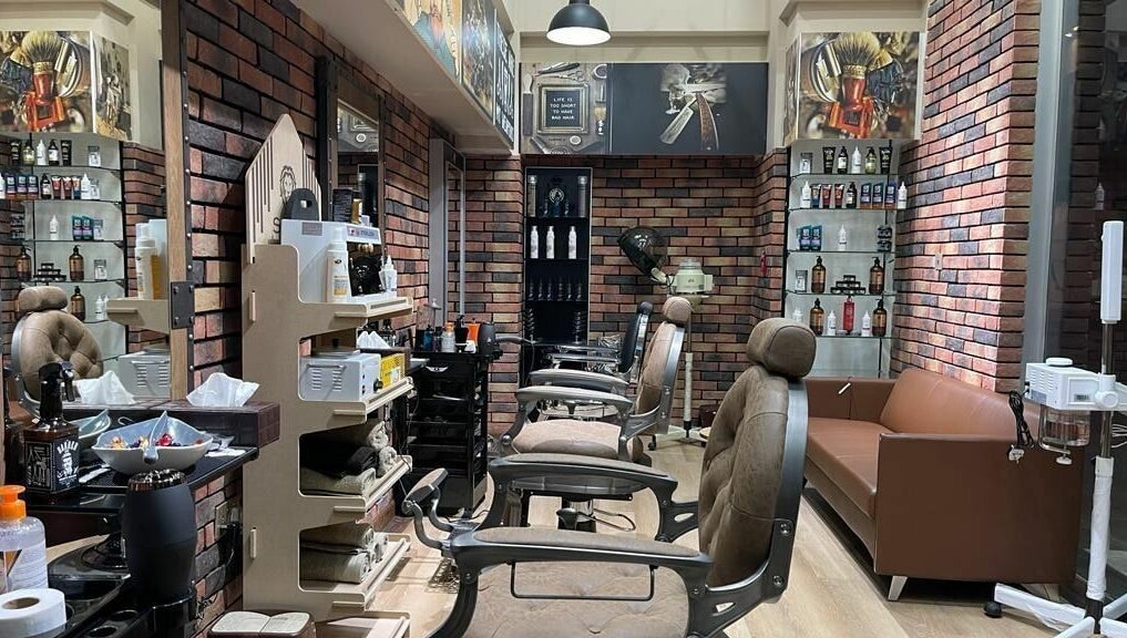 Interior of Gentsy Barber Shop in Dubai, AE showcasing elegant chairs and organized grooming products.