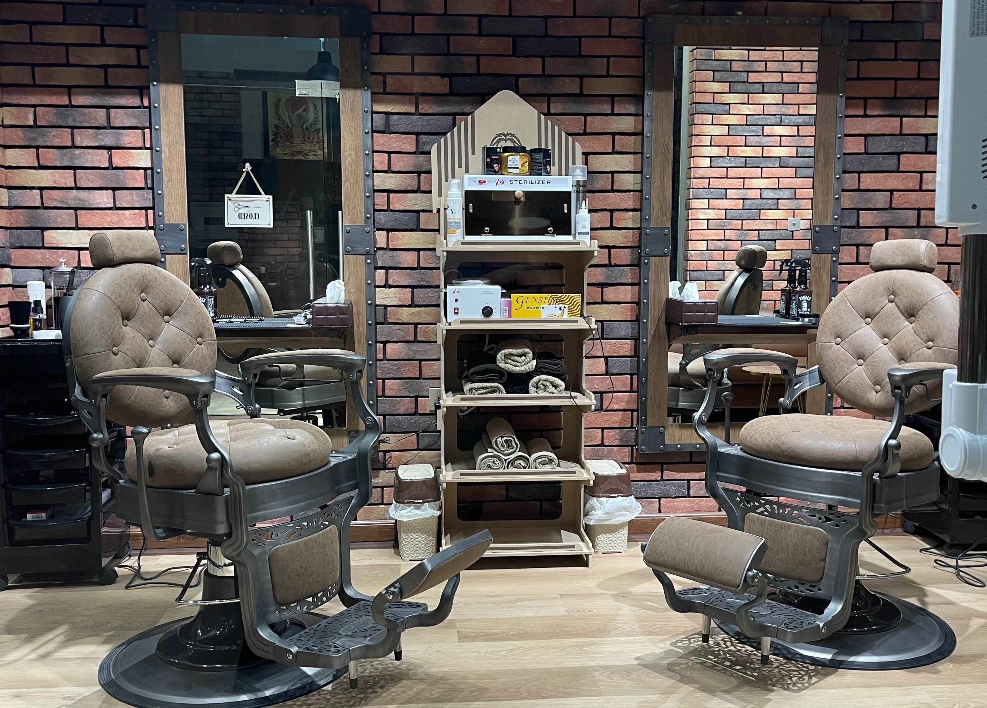 Elegant barber chairs at Gentsy Barber Shop in Dubai, AE, showcasing a stylish and comfortable grooming environment.
