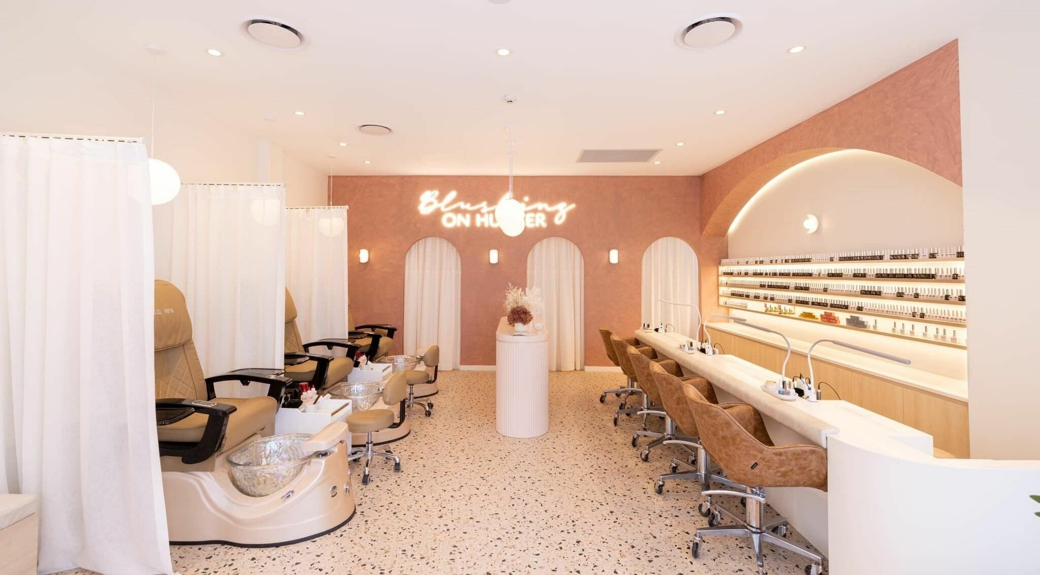 Elegant interior of Blushing on Hunter, Newcastle, NSW, AU showcasing modern spa pedicure stations.