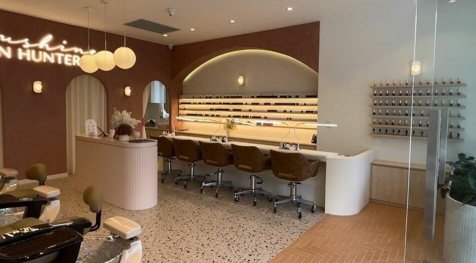 Interior of Blushing on Hunter, Newcastle, New South Wales; stylish salon with manicure stations and serene decor.