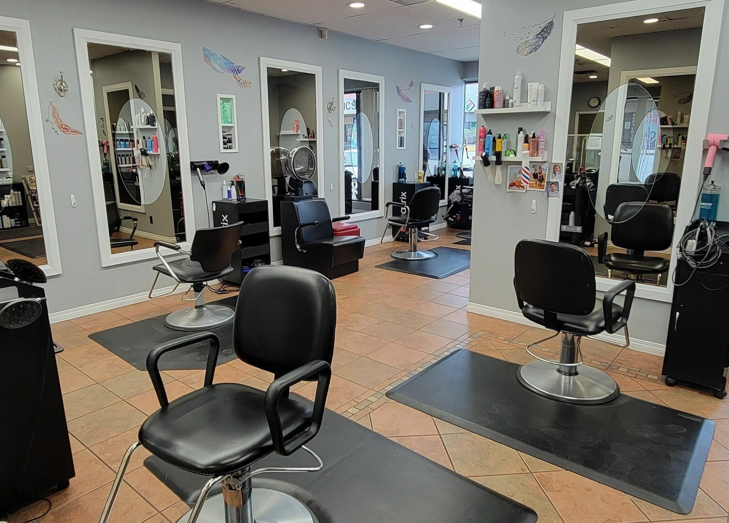 Modern salon interior at Visible Changes Hair Design in Calgary, Alberta, CA, showcasing stylish chairs and mirrors.