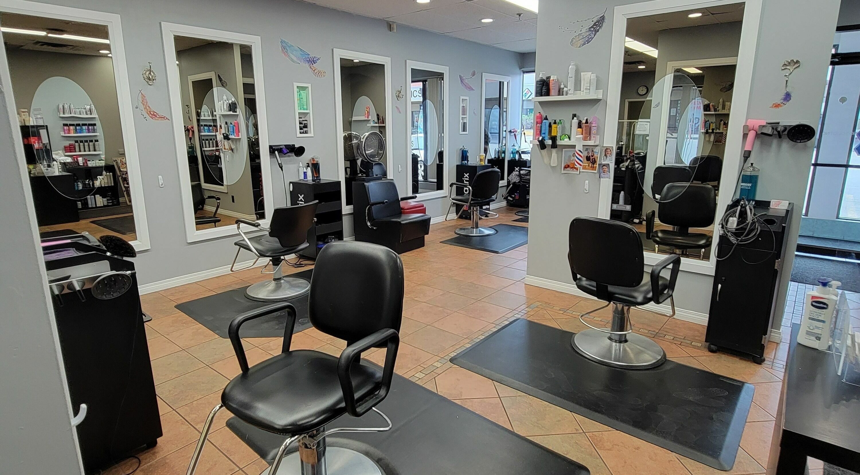 Modern salon interior at Visible Changes Hair Design in Calgary, Alberta, CA, showcasing stylish chairs and mirrors.