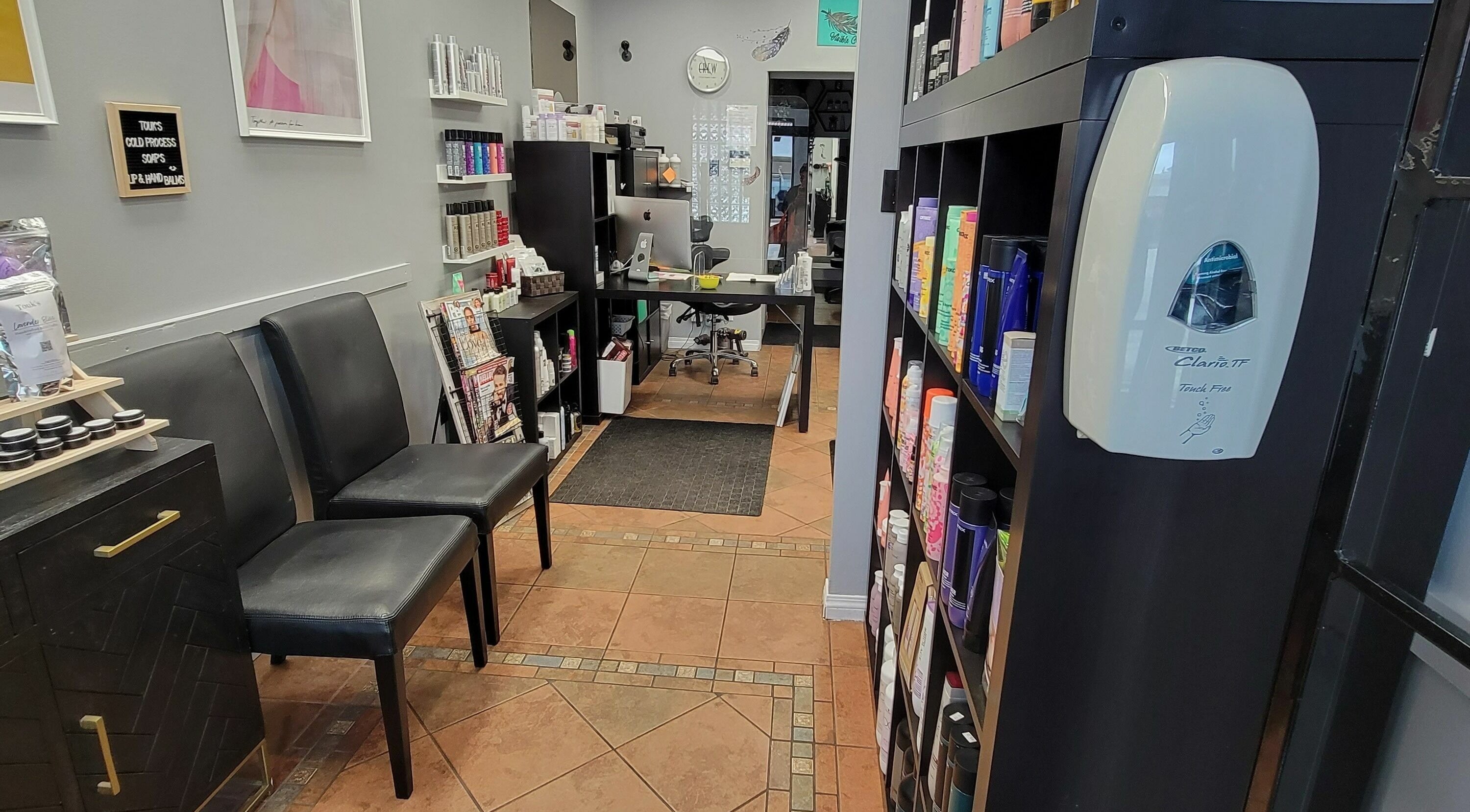 Interior of Visible Changes Hair Design in Calgary, Alberta, CA, showcasing stylish decor and product shelves.