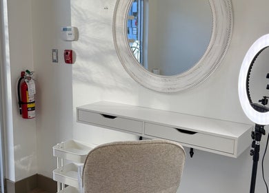 Elegant salon setup at Beauty Zone by YZ in Port Moody, British Columbia, CA, featuring a round mirror and ring light.