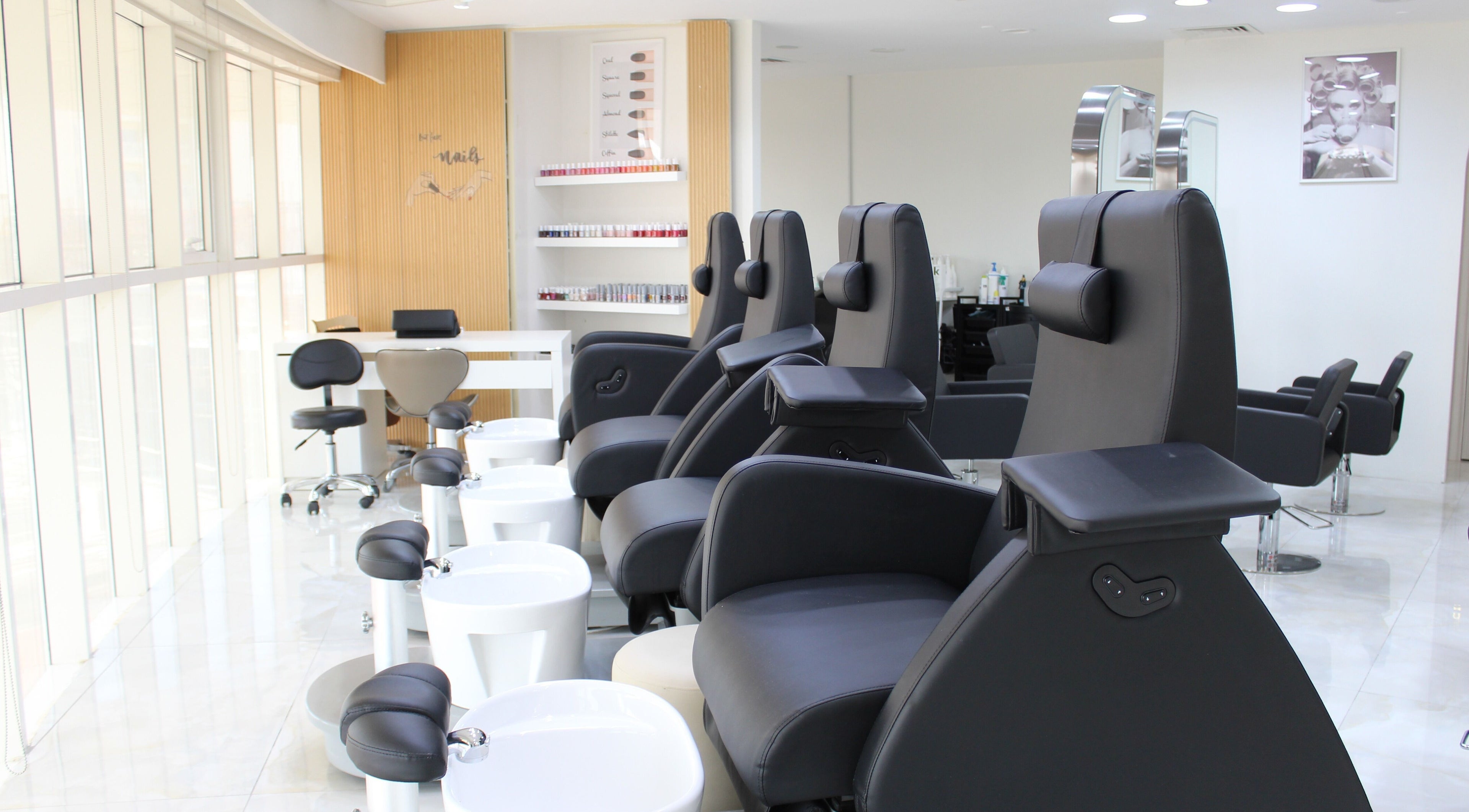 Modern pedicure chairs at Buff and Blow Beauty and Care in Abu Dhabi, AE, offering a luxurious nail experience.
