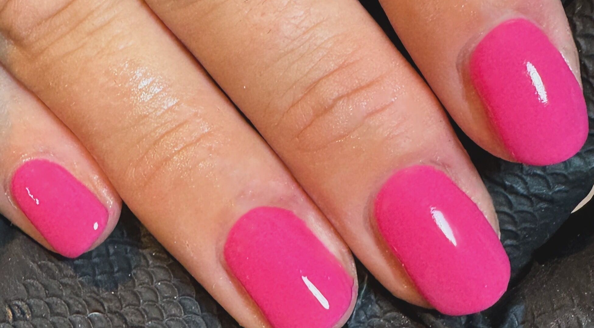 Vibrant pink manicured nails at Claire Georgina Beauty Room, Droitwich Spa, England, GB.