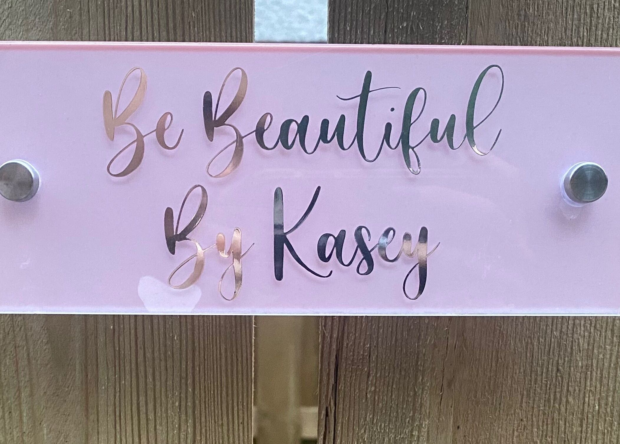 Elegant pink sign of Be Beautiful by Kasey located at Contin, Scotland, GB, showcasing luxurious beauty services.