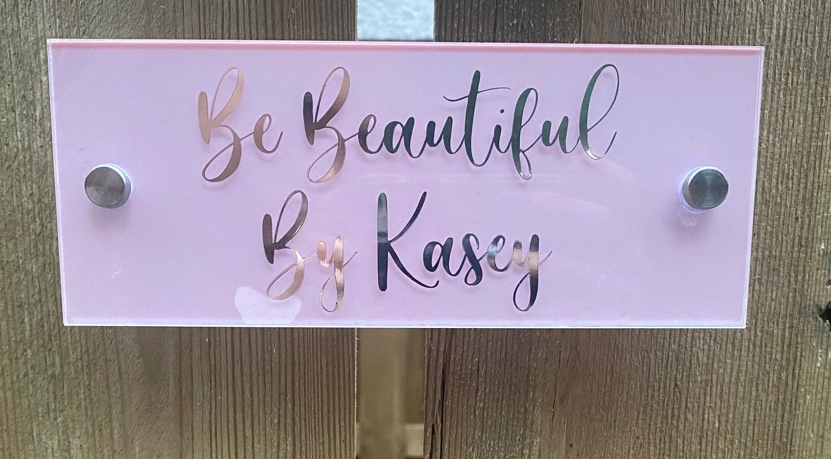 Elegant pink sign of Be Beautiful by Kasey located at Contin, Scotland, GB, showcasing luxurious beauty services.