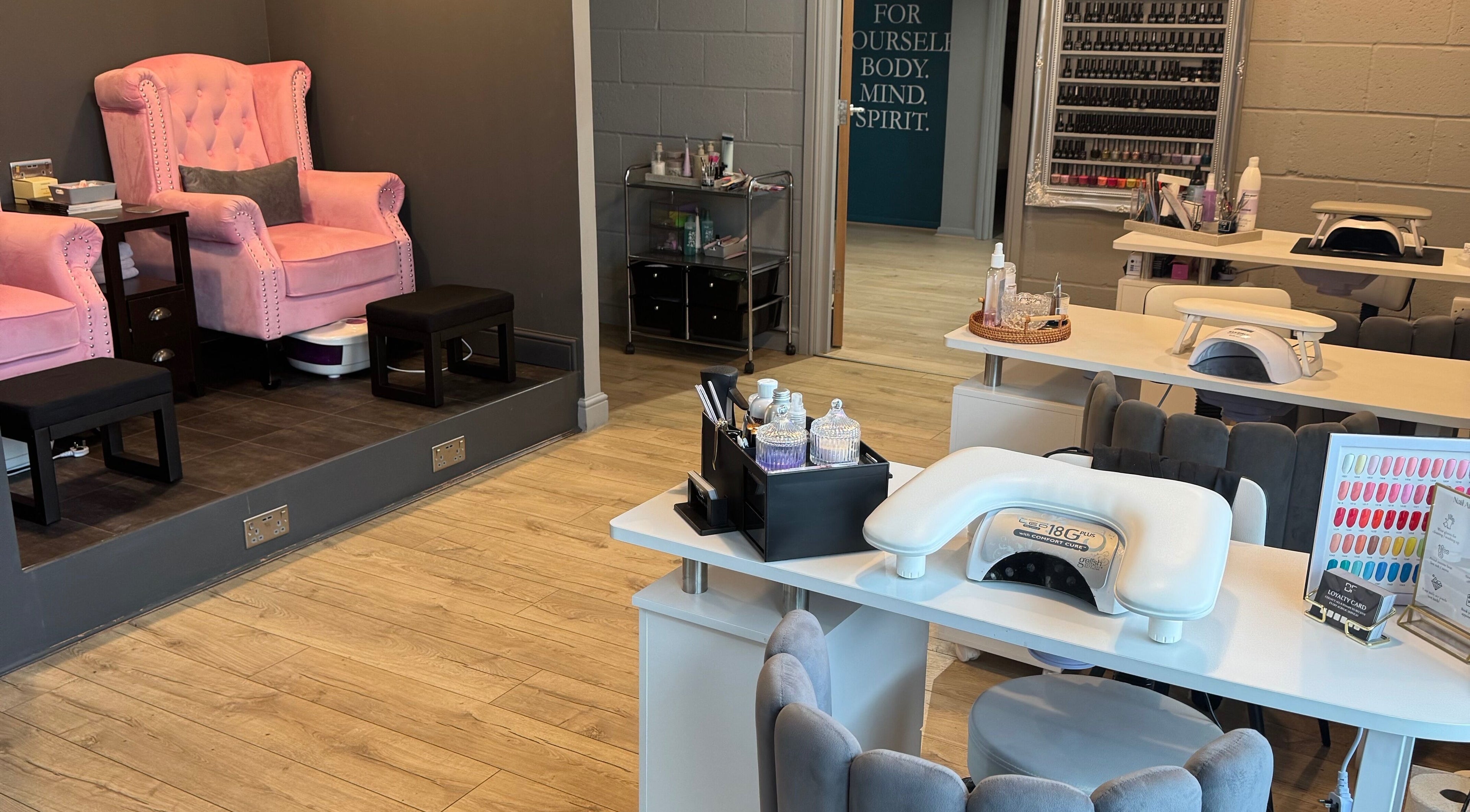 Serenity on Priors & Serenity Beauty in Weldon Corby, England. Elegant pink chairs and nail salon setup.