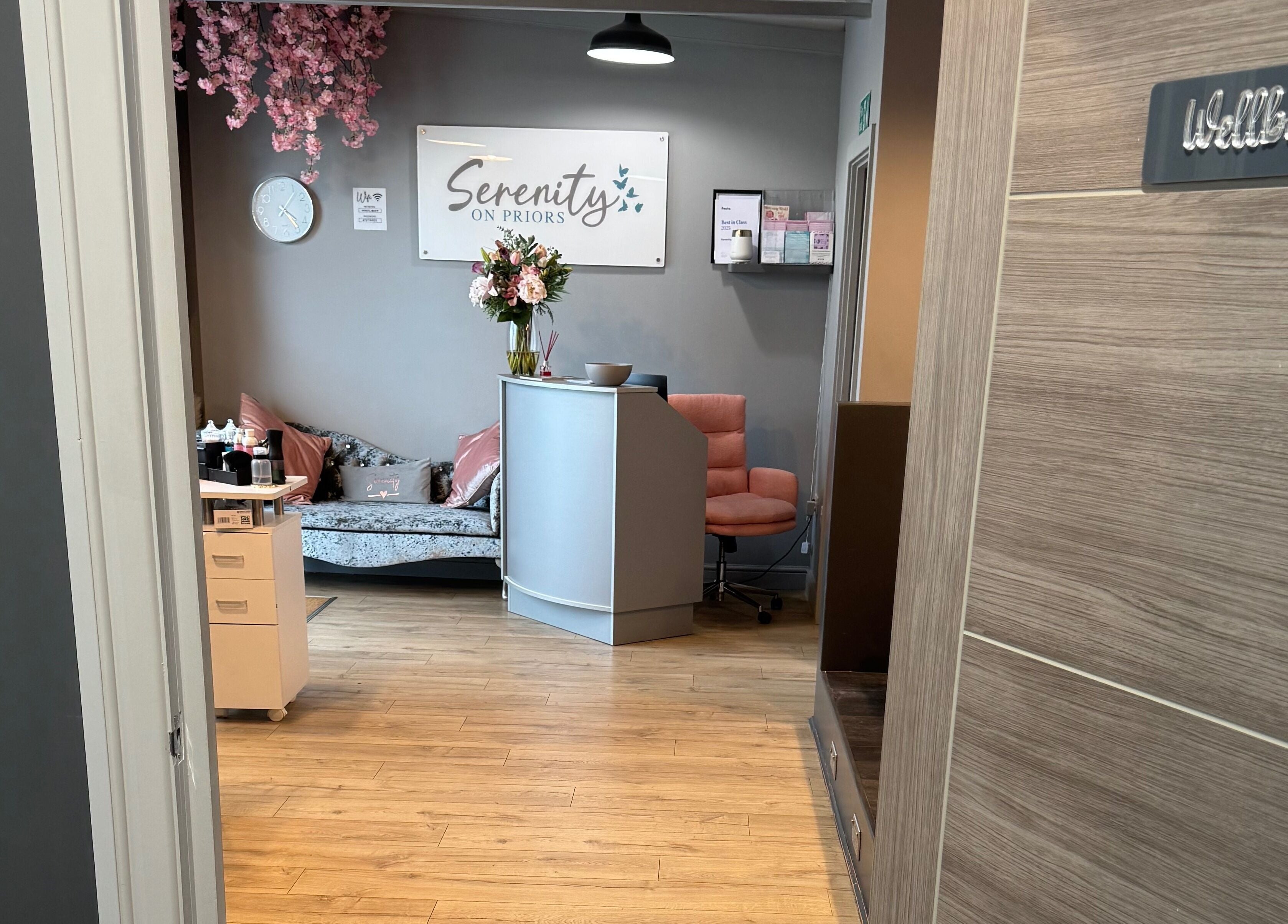 Entrance to Serenity on Priors & Serenity Beauty in Weldon Corby, England featuring a chic lobby with floral decor.