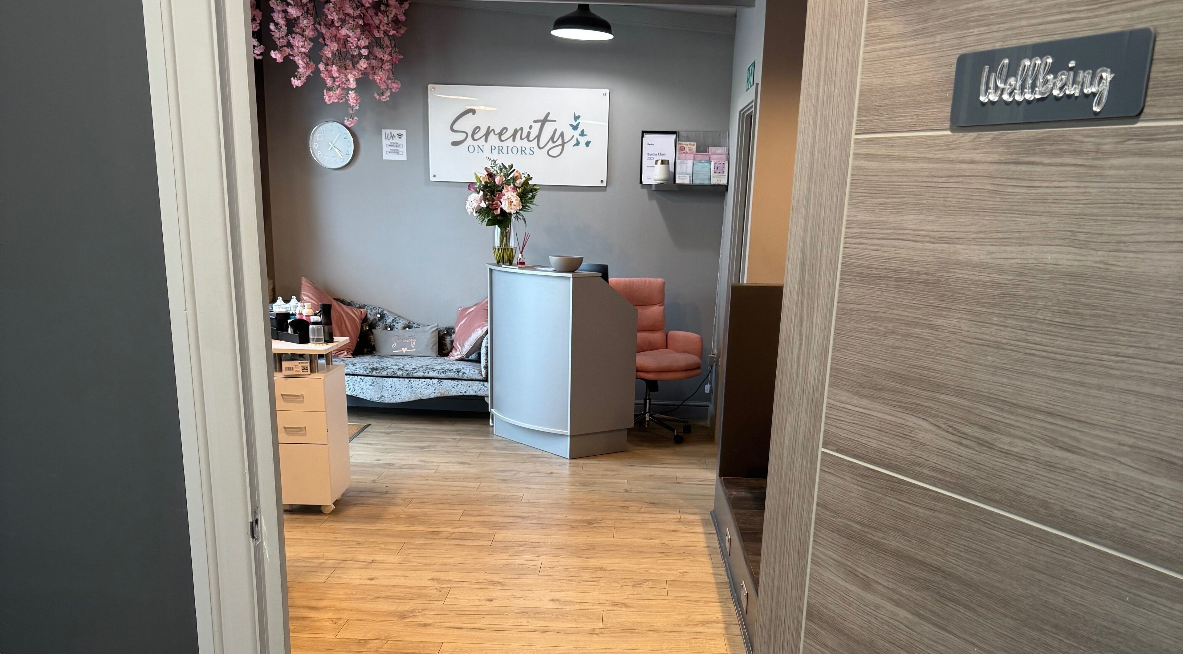 Entrance to Serenity on Priors & Serenity Beauty in Weldon Corby, England featuring a chic lobby with floral decor.