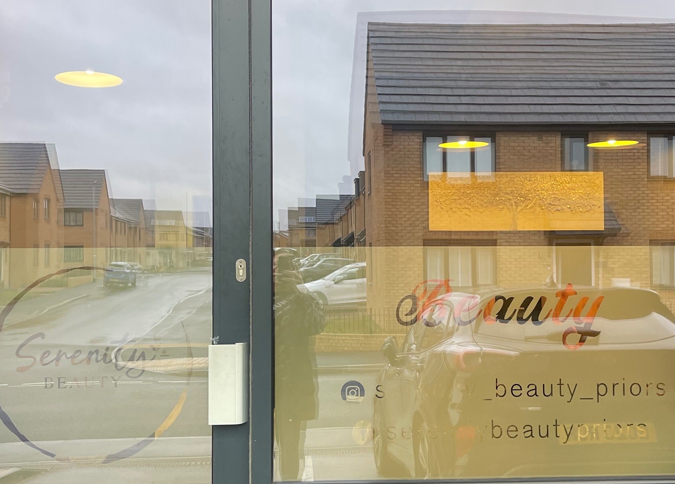 Entrance of Serenity on Priors & Serenity Beauty in Weldon Corby, England, GB showcasing reflective glass door.