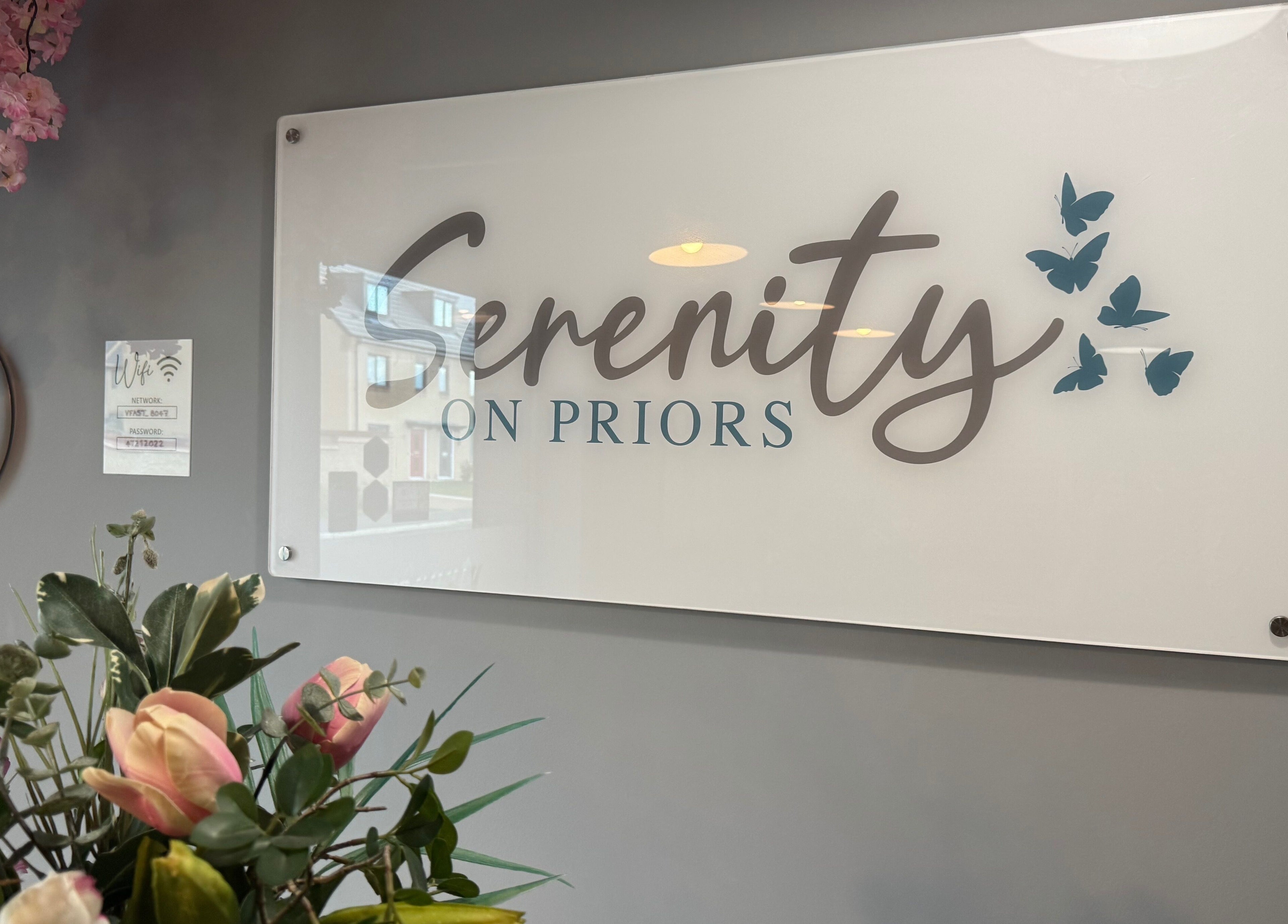 Serenity on Priors signage with floral decor at Weldon Corby, England, GB. Tranquil beauty at Serenity Beauty.