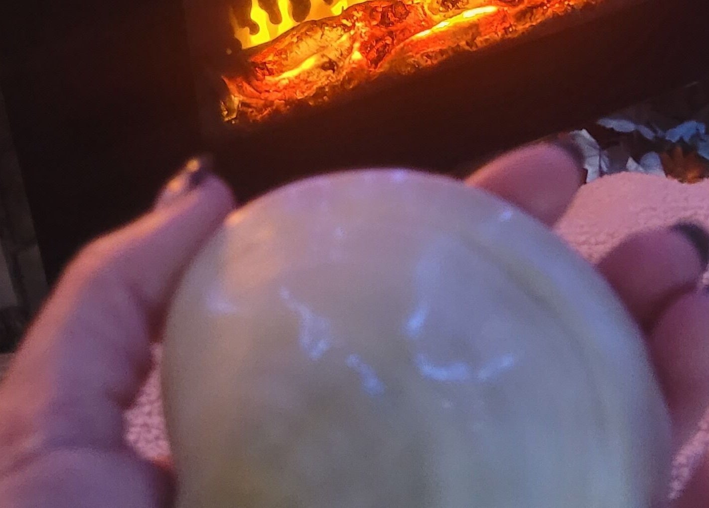 Soothing therapy stone held before a warm fire at Magical Owl Holistic Therapy, Ash Nr Canterbury, England, GB.