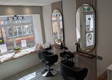 Elegant salon interior at Hair Necessities, Newton Abbot, United Kingdom, GB with mirrored styling stations.