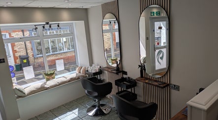Elegant salon interior at Hair Necessities, Newton Abbot, United Kingdom, GB with mirrored styling stations.