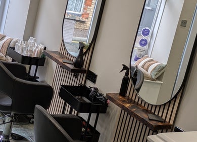 Modern salon chairs and mirrors at Hair Necessities, Newton Abbot, United Kingdom, GB.