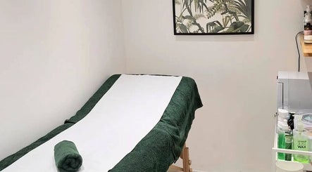 Therapy room at Wild Beauty, London, England, GB, featuring a neatly prepared massage table and tranquil decor.