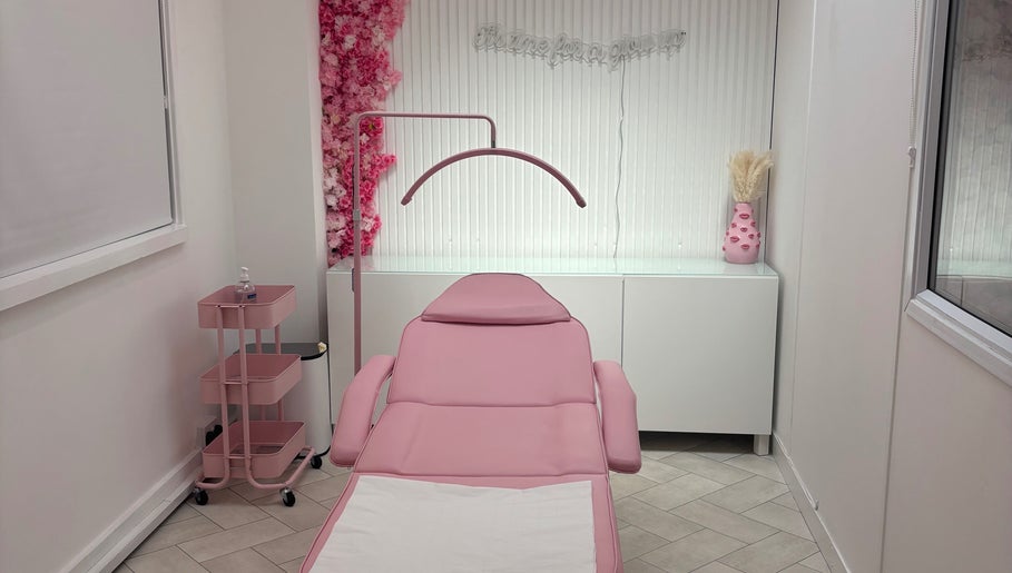 Elegant treatment room at House of Angels, St Albans, England, GB, featuring a pink aesthetic and floral decor.