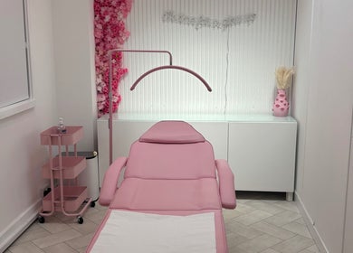 Elegant treatment room at House of Angels, St Albans, England, GB, featuring a pink aesthetic and floral decor.