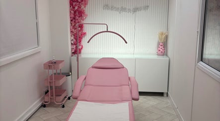 Elegant treatment room at House of Angels, St Albans, England, GB, featuring a pink aesthetic and floral decor.