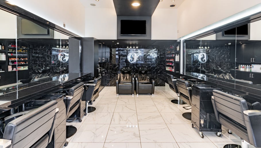 Luxurious interior of Shique London, salon in London, England, GB with sleek black decor and styling stations.
