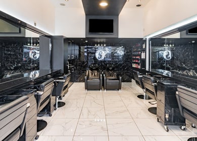 Luxurious interior of Shique London, salon in London, England, GB with sleek black decor and styling stations.