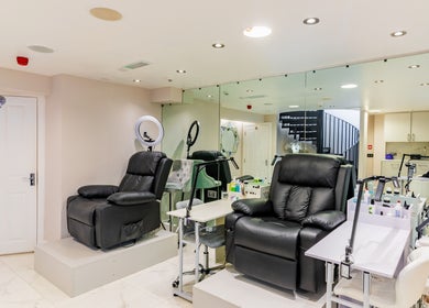 Spacious manicure area at Shique London, located in London, England, GB with plush chairs and modern decor.