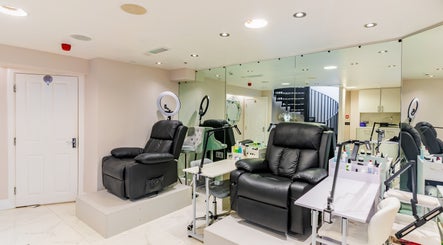 Spacious manicure area at Shique London, located in London, England, GB with plush chairs and modern decor.