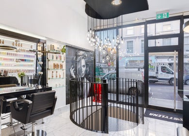 Interior of Shique London, a chic beauty venue in London, England, GB with stylish chairs and product displays.