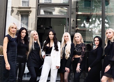 Shique London team in fashionable attire outside venue in London, England, GB.